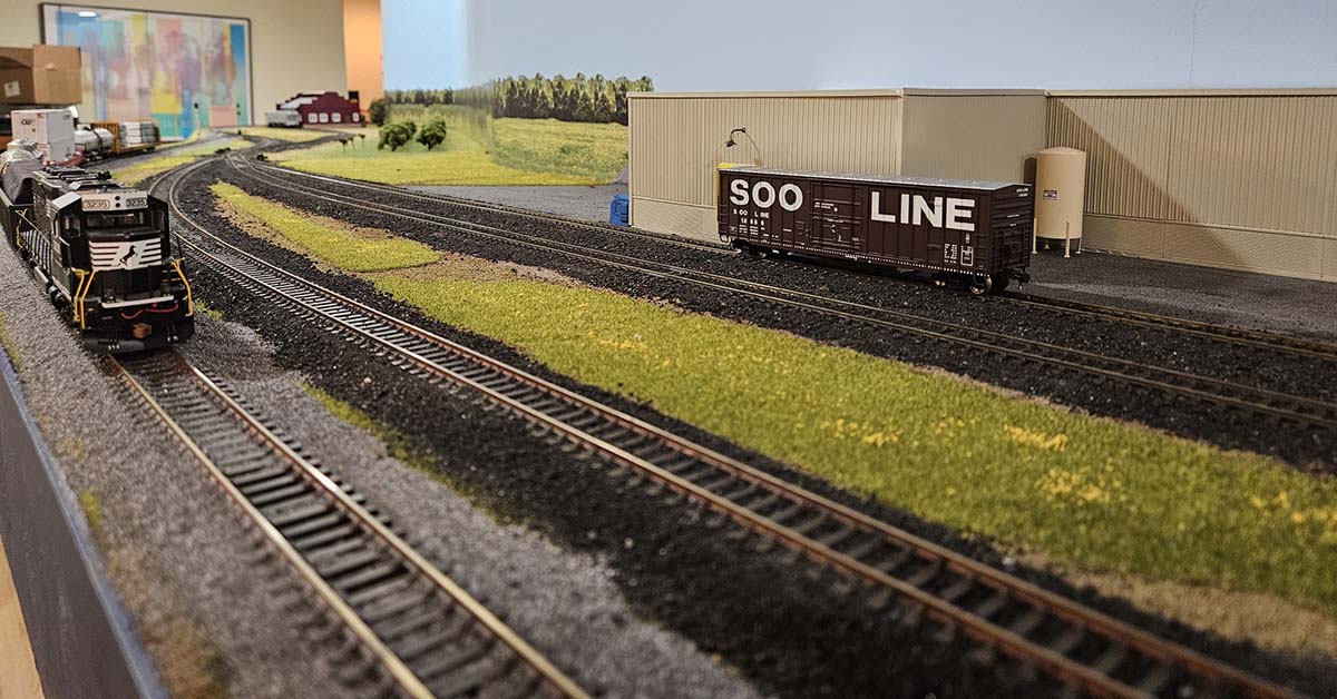 SD40-2 Leading Train past Alpha Baking