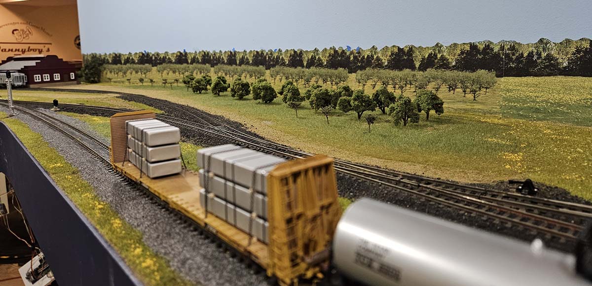 Train end with Orchard in Background