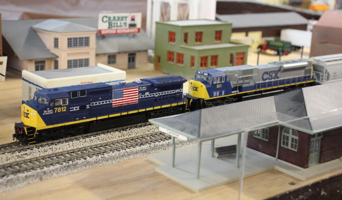 A CSX freight passes the station in Carlsville